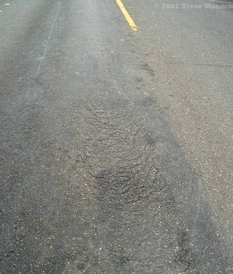 Slippage cracks at an intersection.