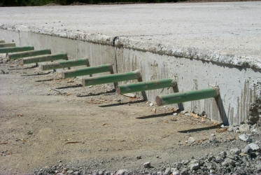 Dowel bars in place at a construction joint- the green color is from the epoxy coating.