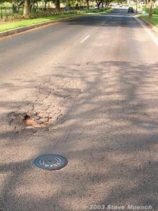 Pothole forming from a badly fatigued wheelpath area on an arterial. Notice the water in the pothole even though it has not rained in almost 12 hours.