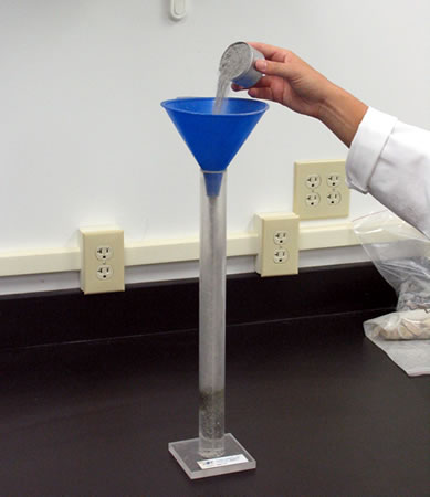Pouring a sample into the graduated cylinder